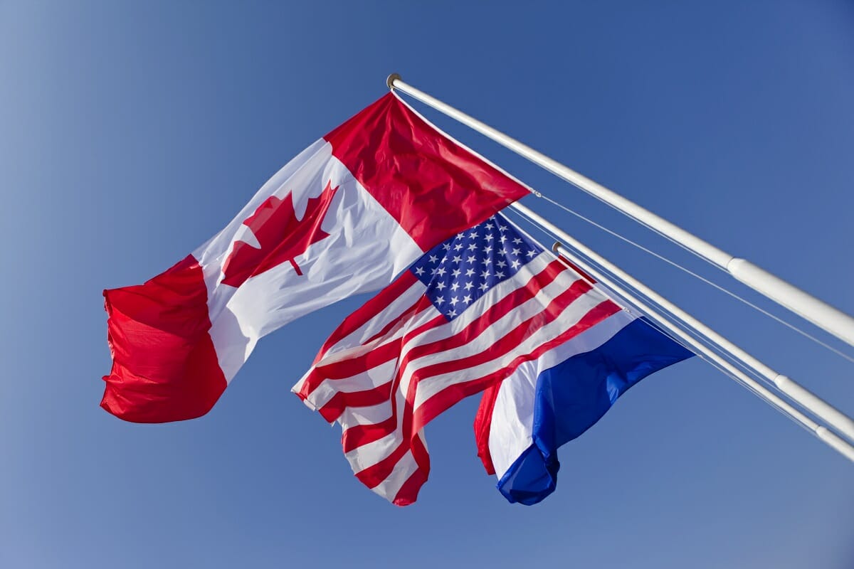 Flags on a sky background Choose Luxembourg for your coming investments