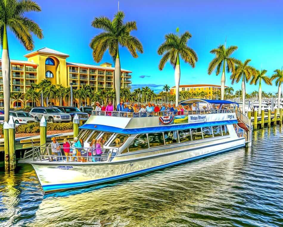 Luxury sightseeing boat operated by Pure Florida departing Naples marina under sunny skies